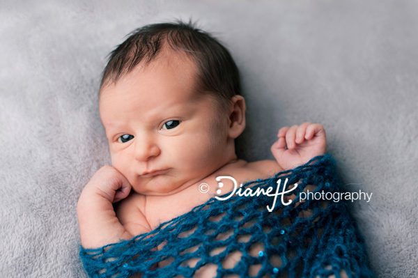 Awake Newborn Baby Poses in blue wrap