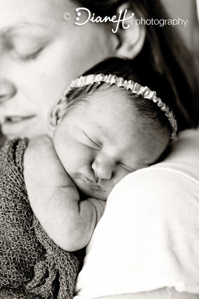 Sleeping Newborn baby sleeps on Moms shoulder
